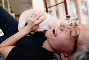 person laughing from puppy