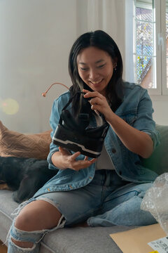 Girl Opening E-commerce Package With VR Glasses.