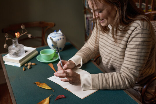 Happy woman expressing her creativity at the desk