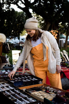 Happy woman shopping at flea market