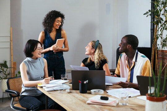 Diverse colleagues discussing project in modern office