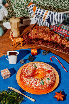 man in pajamas lying next to a king cake