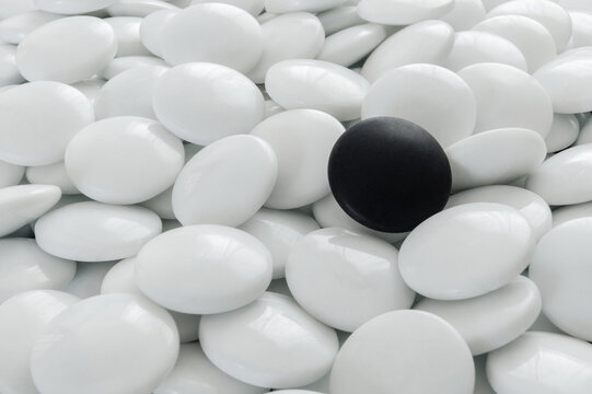Black Go stones between white Go stones.