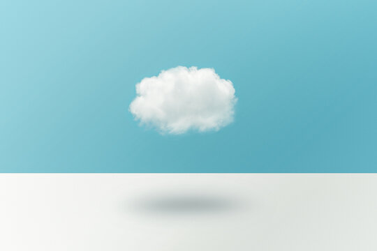Cloud floating in front of a blue wall.