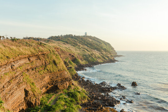 Coastal cliff landscape at sunset.