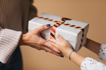 Woman Giving Christmas Present to Little Girl 
