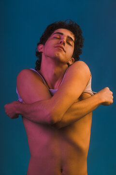 Young queer person getting undressed