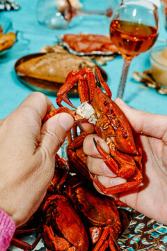 rips off the claw of a crab sitting at a table