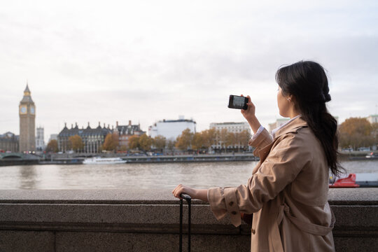 Woman Using Cellphone To Do Photo Of Big Ben