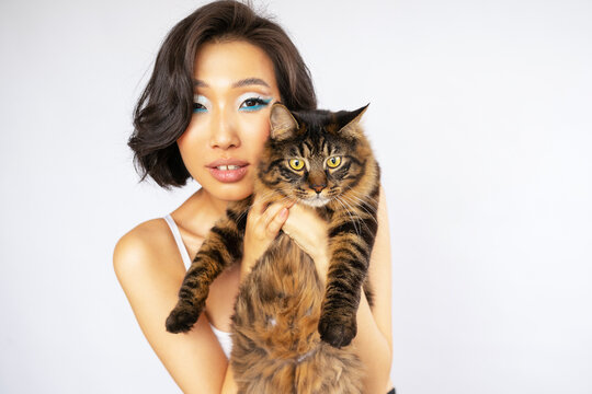 Portrait of Beautiful Young Asian Woman with Bobtail Cat