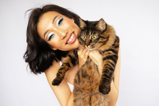 Portrait of Beautiful Young Asian Woman with Bobtail Cat