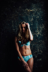 tanned girl in blue lingerie. beautiful figure