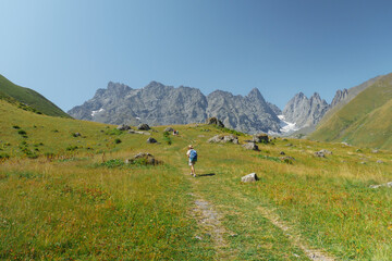 Woman hikes in an alpine mountain area