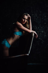 Fototapeta premium tanned girl in blue lingerie. beautiful figure