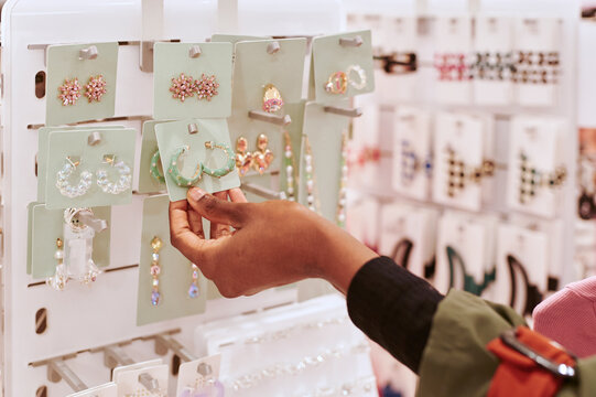 Woman looking at earrings in a store
