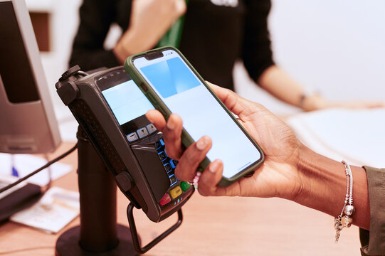 Woman paying for a purchase with her phone