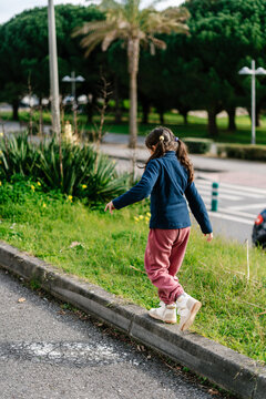 Anonymous girl walking on border