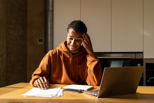 Man paying utility bills from home calculating expenses