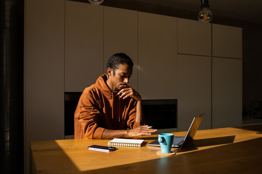 Man paying utility bills from home calculating expenses
