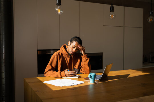 Man paying utility bills from home 