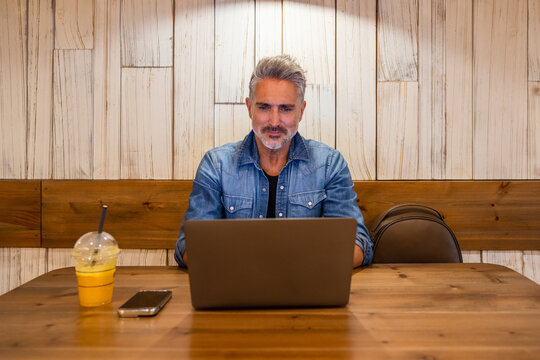 Senior man working on laptop