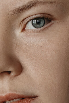 Close Up woman's portrait with grey eyes and blonde hair and lips