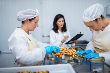 Employees of factory canning seafood product