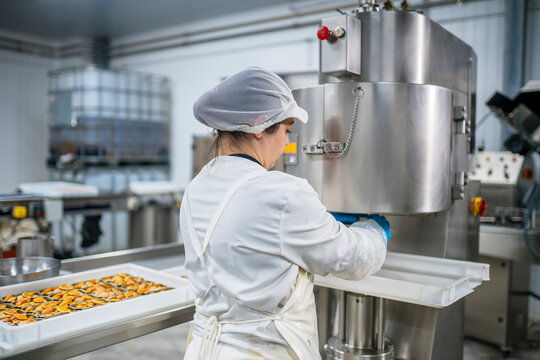 Woman sealing cans with mussels