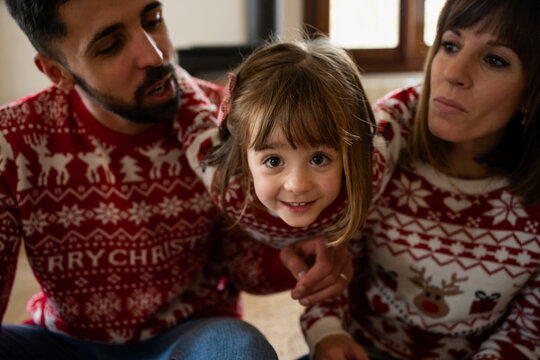 Little girl with her parents at Christmas