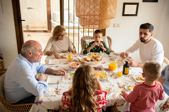 Diverse generation family having Christmas lunch