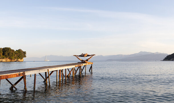Couple doing yoga on jetty