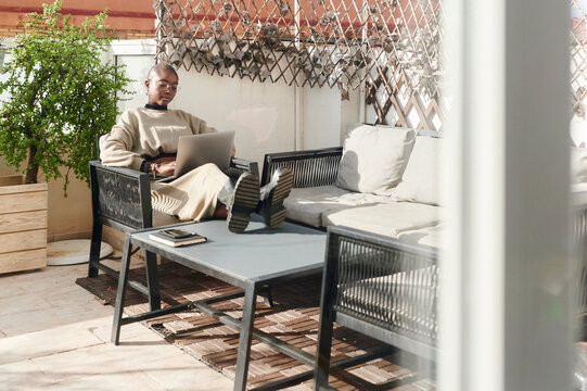 Woman using a laptop on her patio