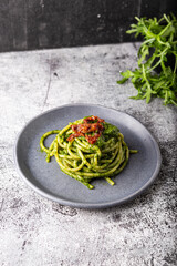 Gragnano spaghetti with homemade rocket pesto and dried tomatoes. Dish suitable for adults and children, healthy and tasty.