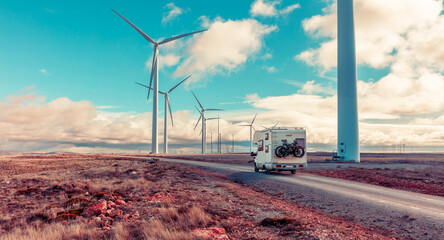 Motorhome near wind turbines eolic renewable energy - obrazy, fototapety, plakaty