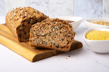 Homemade Gluten Free Bread. Healthy Eating Concept. Millet, buckwheat, psyllium husks, flax seeds on Gray Table.