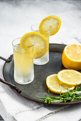 Traditional italian limoncello liqueur, lemon alcohol Digestive with lemon and rosemary. White...