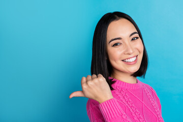 Profile portrait of gorgeous positive girl beaming smile direct thumb finger empty space isolated on blue color background