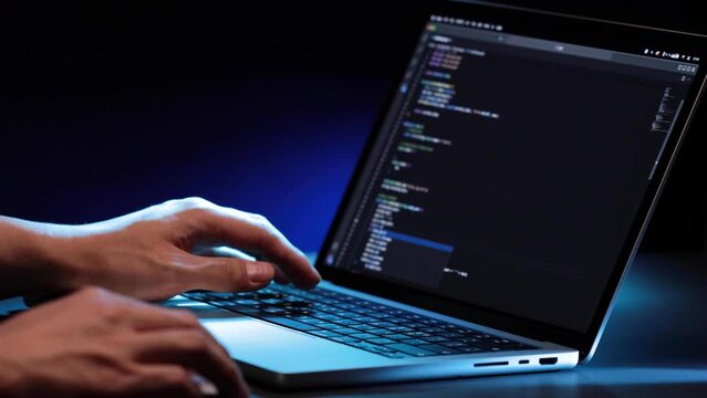 closeup of hands typing codes at late night