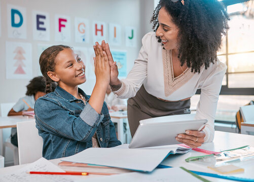Tablet, high five and teacher with child education, learning and support, achievement and classroom goal. Mentor, black woman or person and girl in success hand sign for English, language development