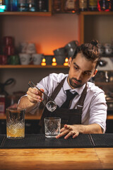 Barman is putting ice ball