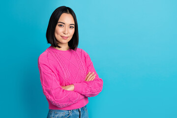 Portrait of positive lovely half turned person folded arms empty space blank isolated on blue color background