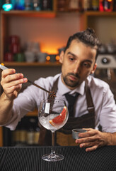 Barman decorating goblet glass
