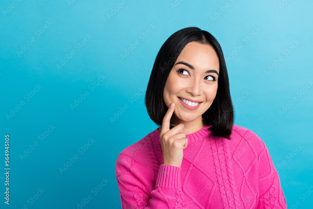 Sticker Photo of dreamy japanese woman touch finger cheekbone toothy smile look empty space want new collection clothes isolated on blue color background