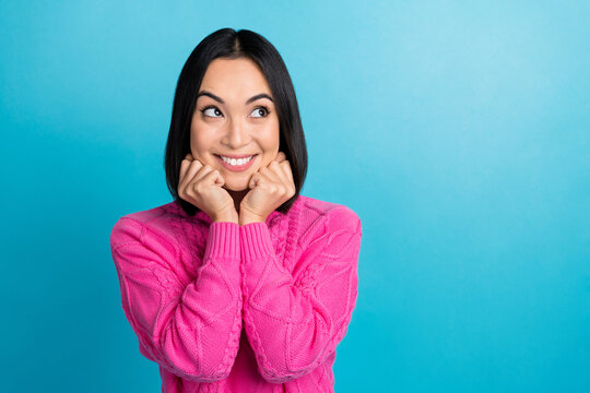 Photo Of Dreaming Lovely Korean Pretty Girl Touch Cheeks Pink Knitwear Positive Looking Empty Space Good Brand Shop Isolated On Blue Color Background