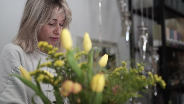Florist in the flower shop making bouquet of flowers