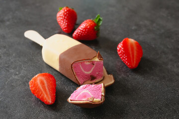 Ice cream with strawberries on a dark background