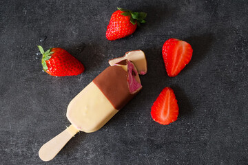 Ice cream with strawberries on a dark background