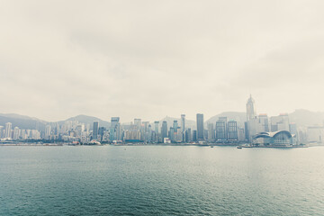 Hong Kong city skyline at sunset with fog