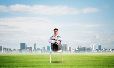 Fototapeta premium scared businessman on a chair