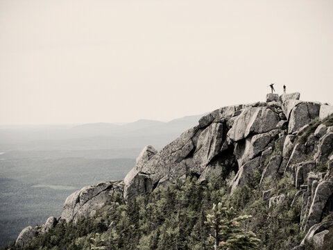 Hikers pose on the rocky summit of Doubletop Mountain in Maine's Baxter State Park.